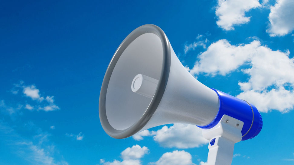 Megaphone, blue sky with small clouds